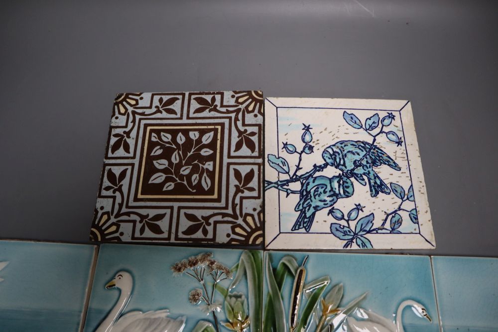 A set of four Victorian coloured tiles, 15cm and two other tiles